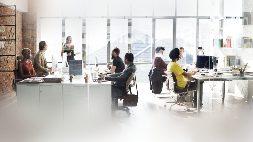 diverse people working at office desks registering a company
