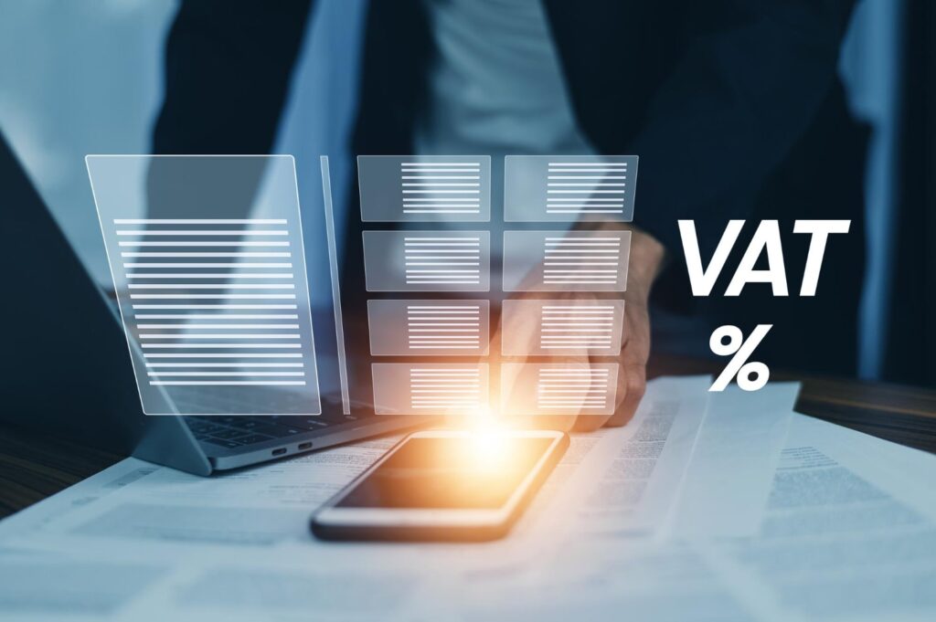 Businessman managing VAT on digital devices